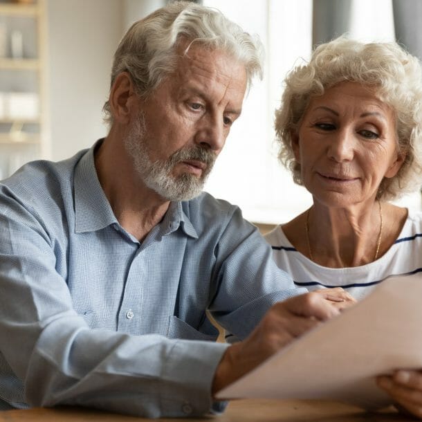 older couple looking at paper