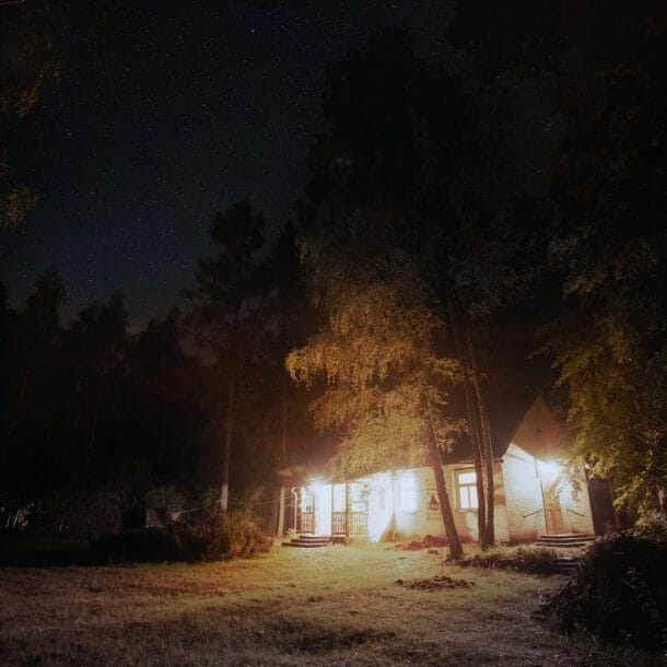 Brightly Lit House in Dark Woods