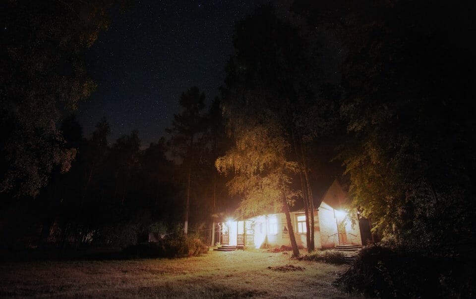 Brightly Lit House in Dark Woods